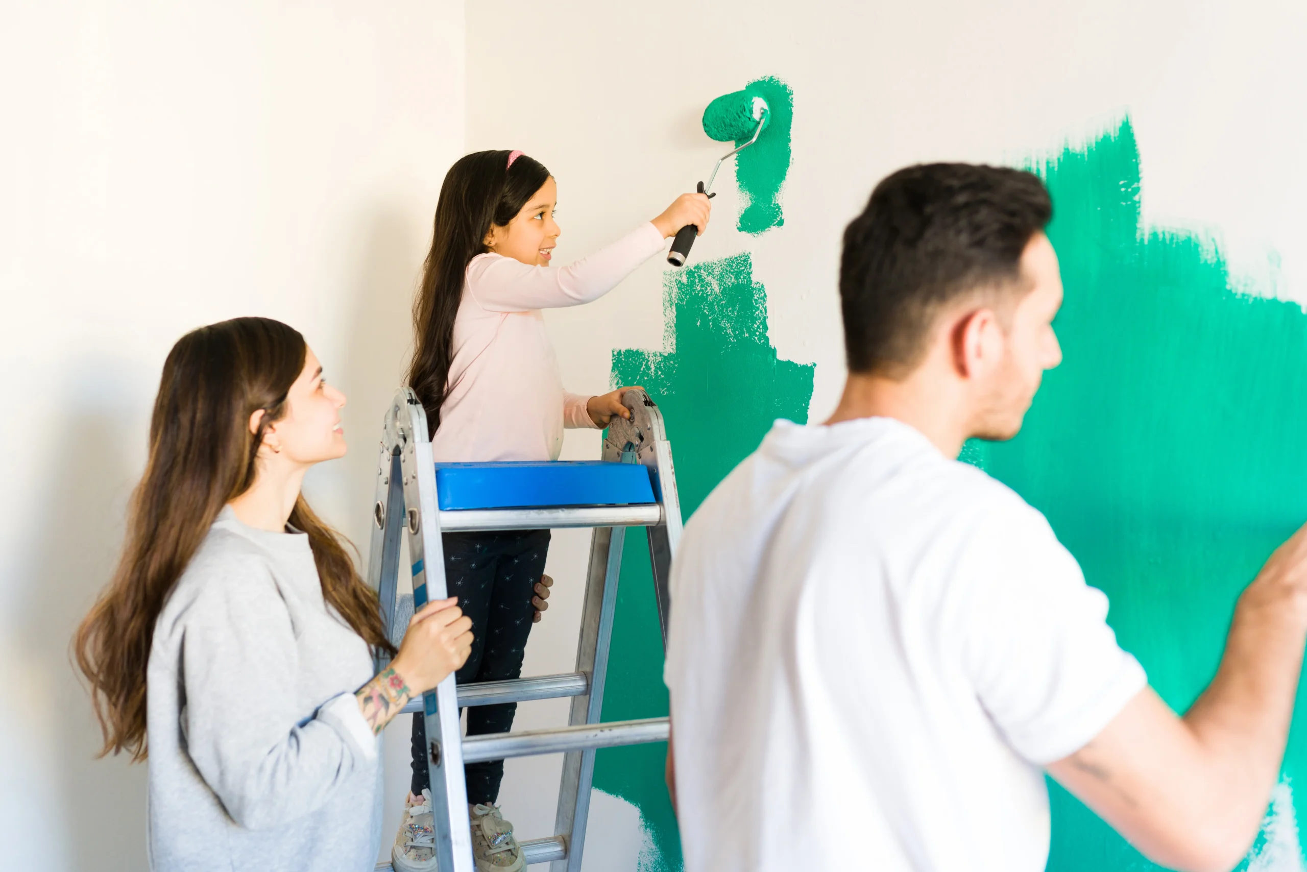 family painting interior walls together using paint roller at adura paint emporium