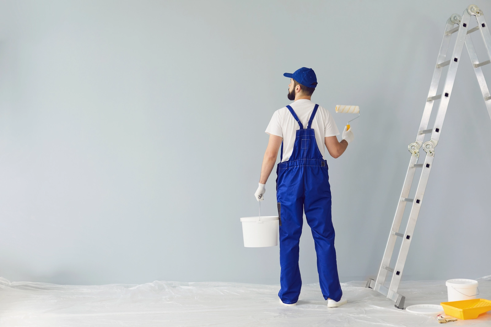 professional house painting work using roller at adura paint emporium